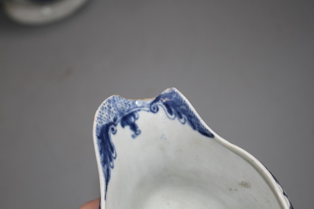A Lowestoft blue and white sauceboat, c.1770 and two Worcester blue and white sauceboats, c.1758-65,